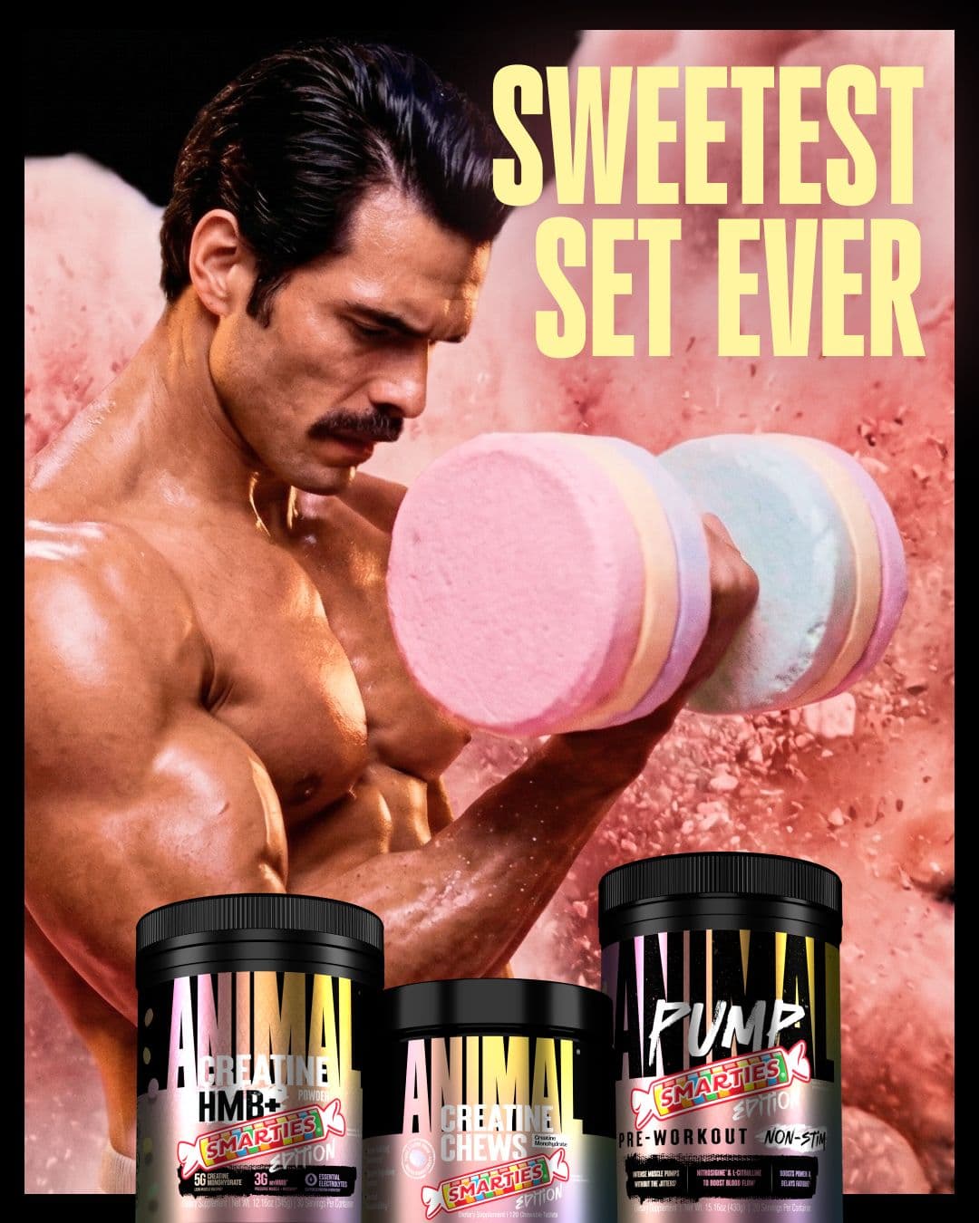 Bodybuilder curling a Smarties-candy dumbbell next to "Sweetest Set Ever" headline and three ANIMAL x Smarties product tubs.