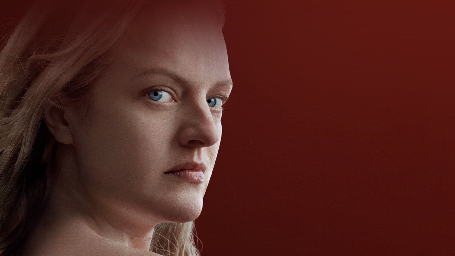 A woman turned to her right side looking at the camera with an intense stare