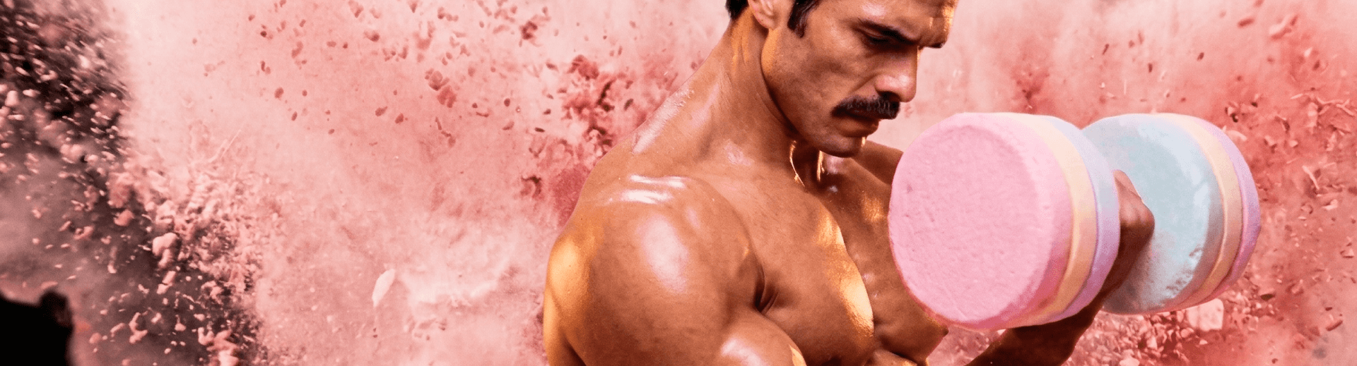Bodybuilder curling a dumbbell made of colorful Smarties candy, set against a cloud of pastel candy powder — ANIMAL x Smarties campaign creative.